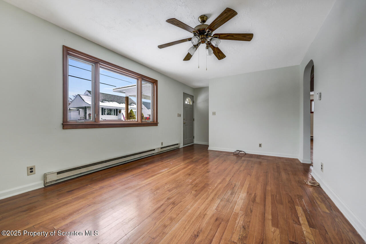 113 Taroli Street Old Forge, PA 18518 - Photo 7 of 41 a view of empty room with wooden floor and fan