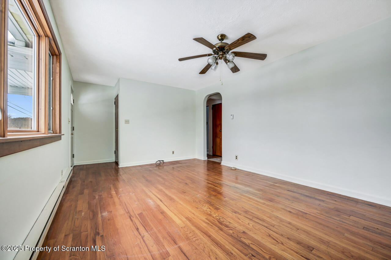113 Taroli Street Old Forge, PA 18518 - Photo 8 of 41 a view of an empty room with wooden floor and a window