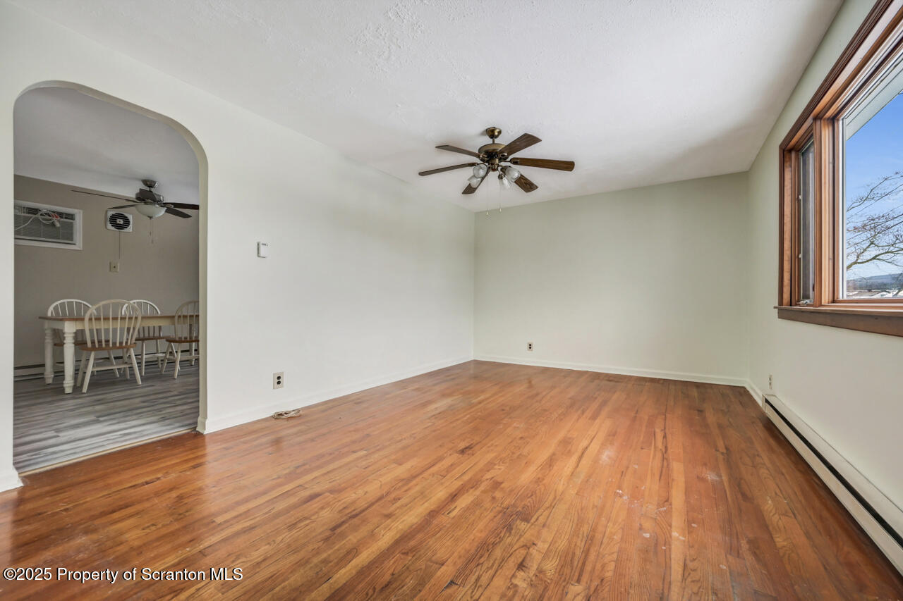 113 Taroli Street Old Forge, PA 18518 - Photo 9 of 41 wooden floor in an empty room with a window