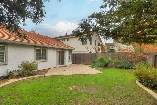 a bathroom with a granite countertop sink and mirror