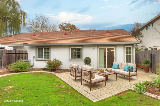 a bedroom with a bed and a dresser with mirror