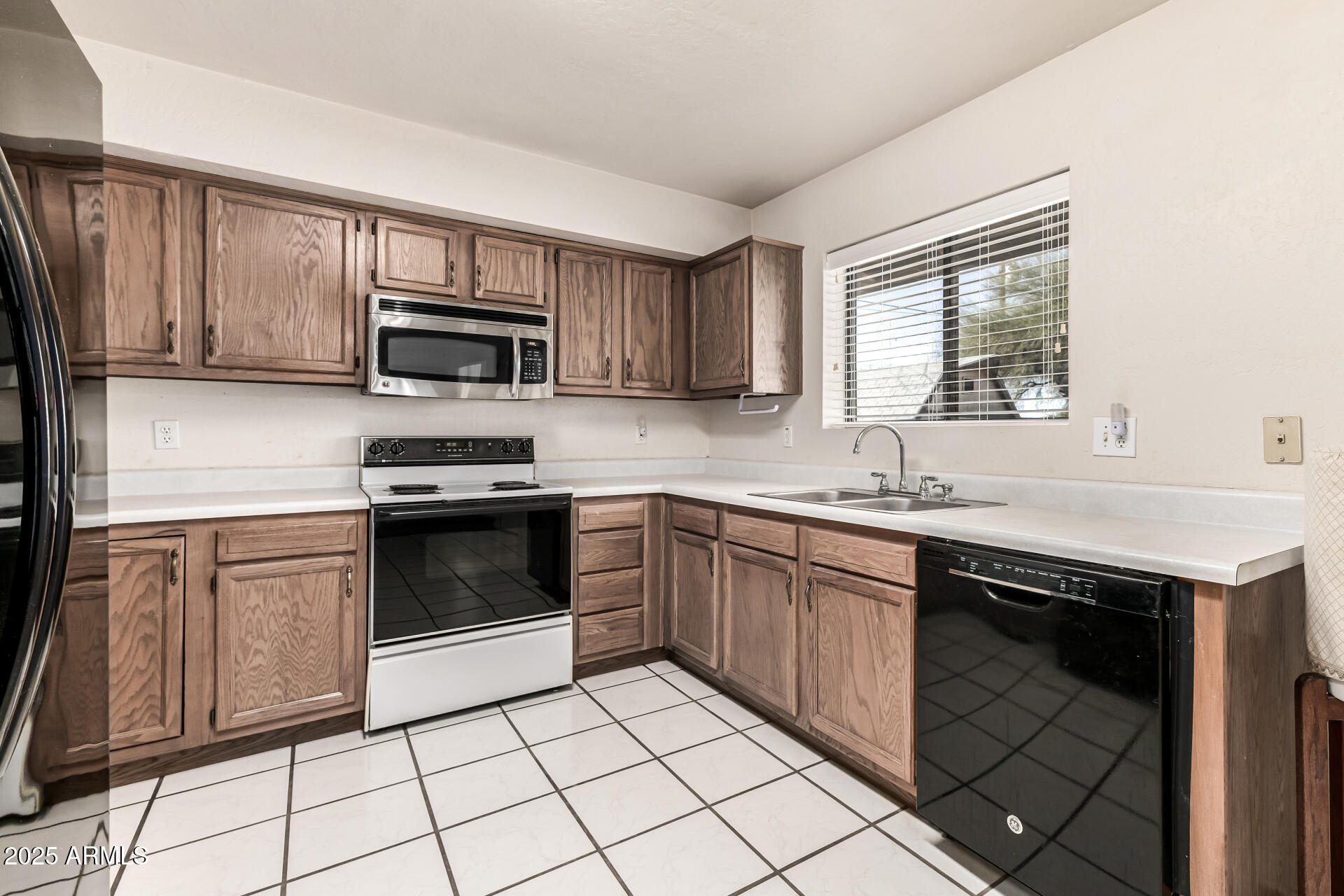 1008 North Meridian Drive Apache Junction, AZ 85120 - Photo 14 of 38 a kitchen with a sink stove top oven and microwave