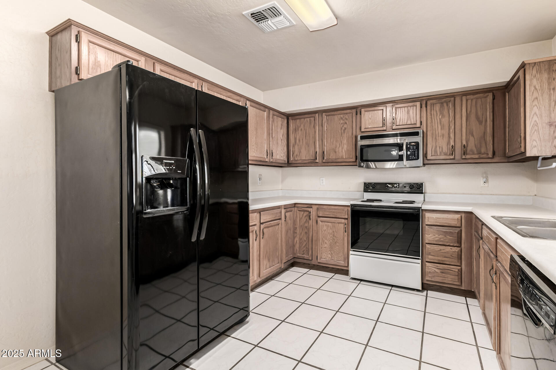 1008 North Meridian Drive Apache Junction, AZ 85120 - Photo 15 of 38 a kitchen with a refrigerator and a stove top oven
