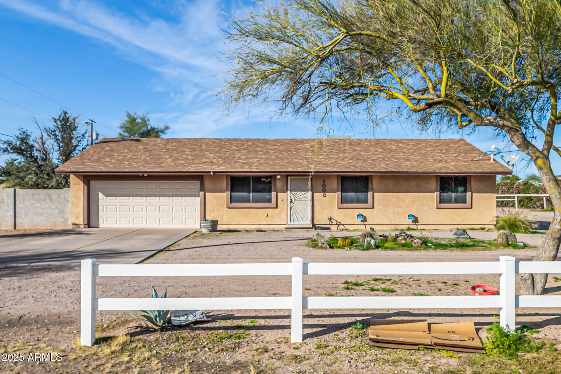 1008 North Meridian Drive Apache Junction, AZ 85120 - Photo 2 of 38 a front view of a house with a garden