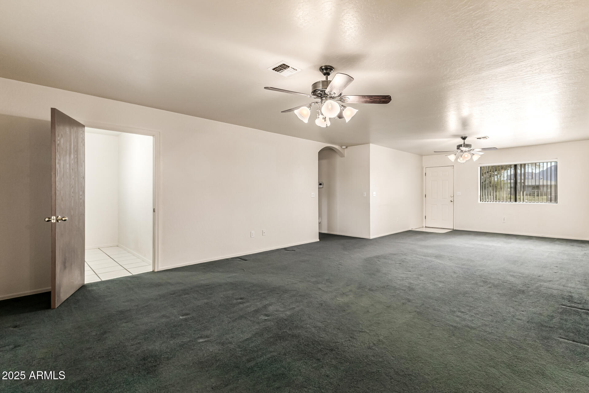 1008 North Meridian Drive Apache Junction, AZ 85120 - Photo 9 of 38 a view of an empty room with a ceiling fan