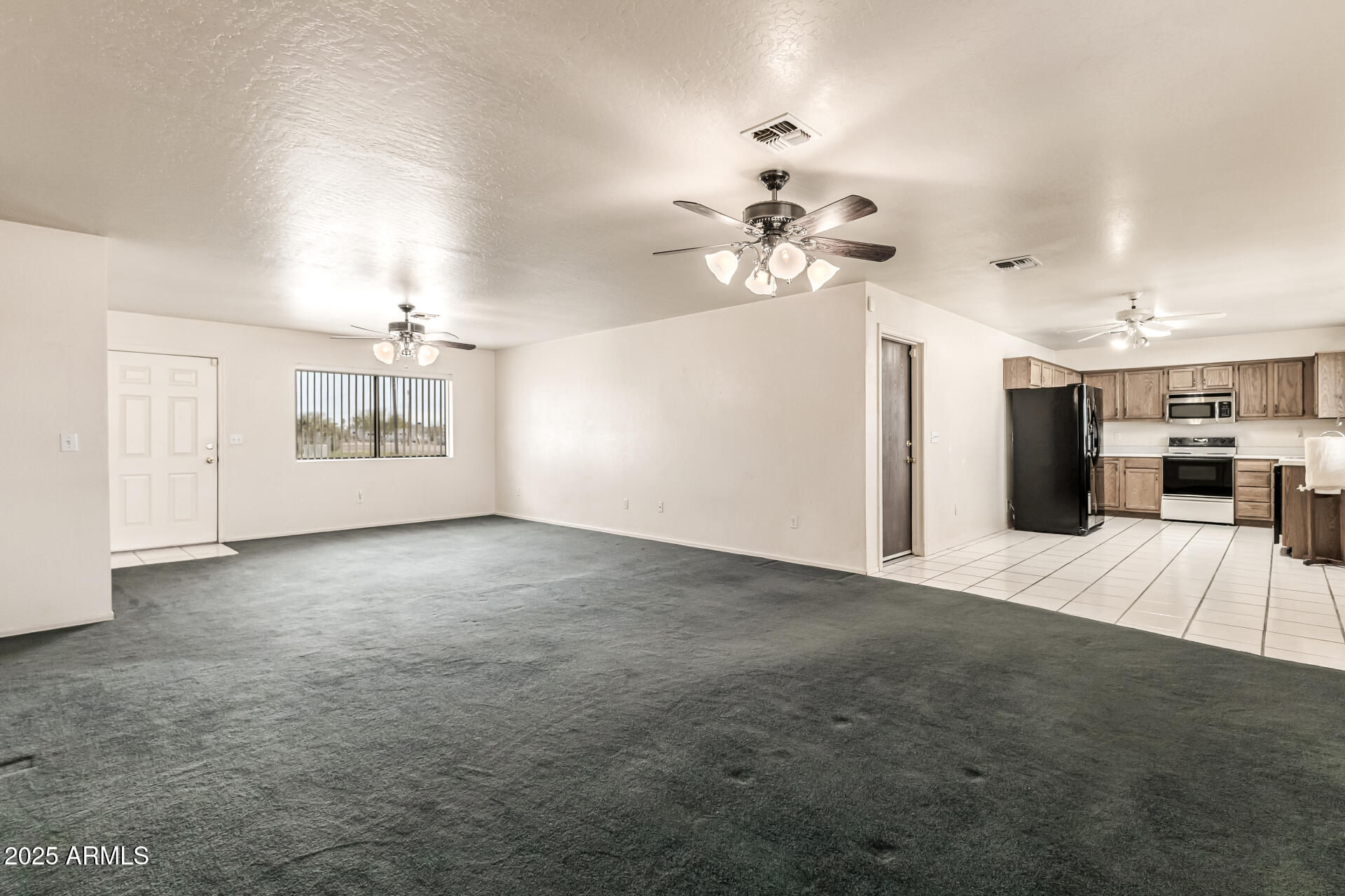 1008 North Meridian Drive Apache Junction, AZ 85120 - Photo 10 of 38 a view of an empty room with a kitchen