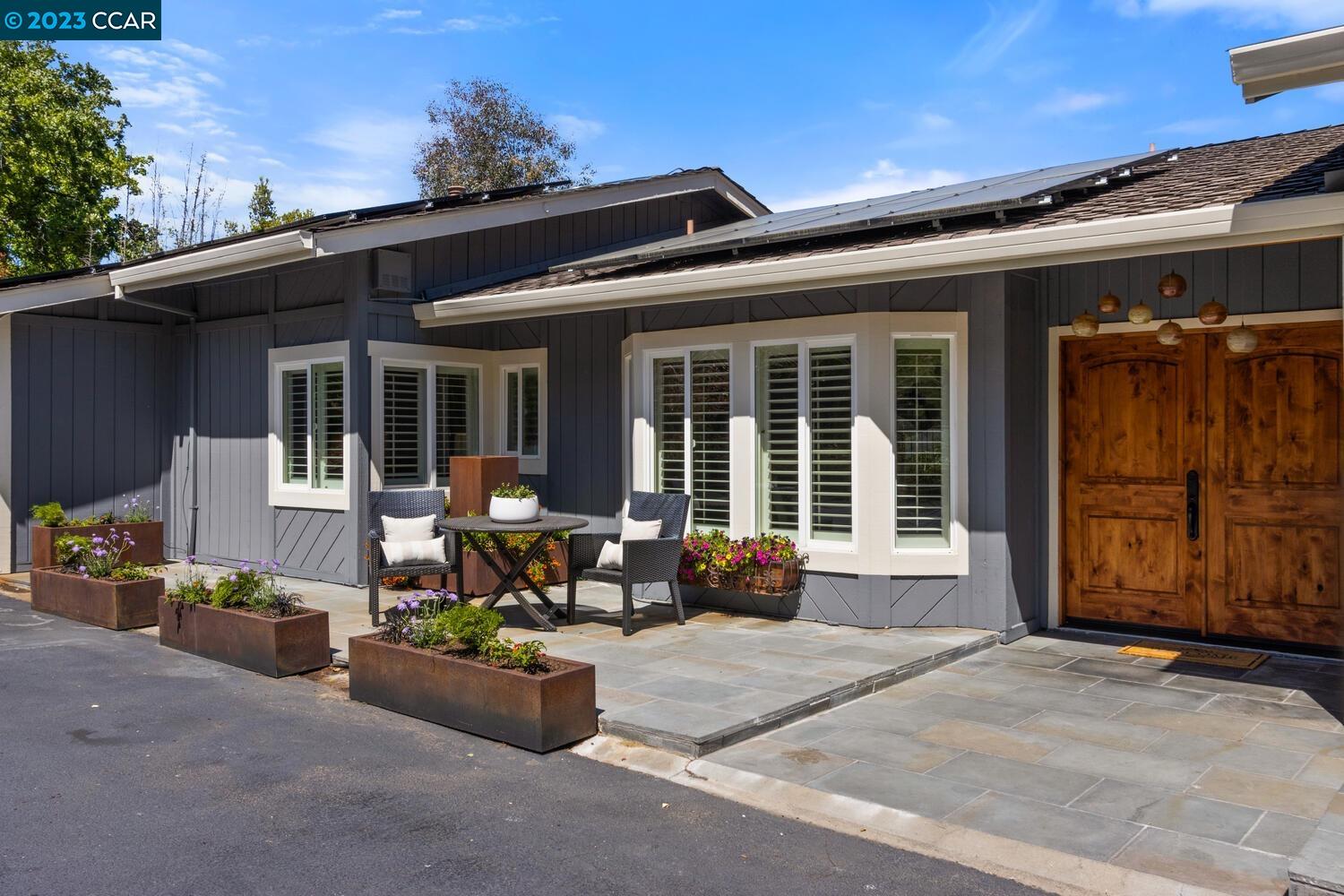 a front view of a house with outdoor seating