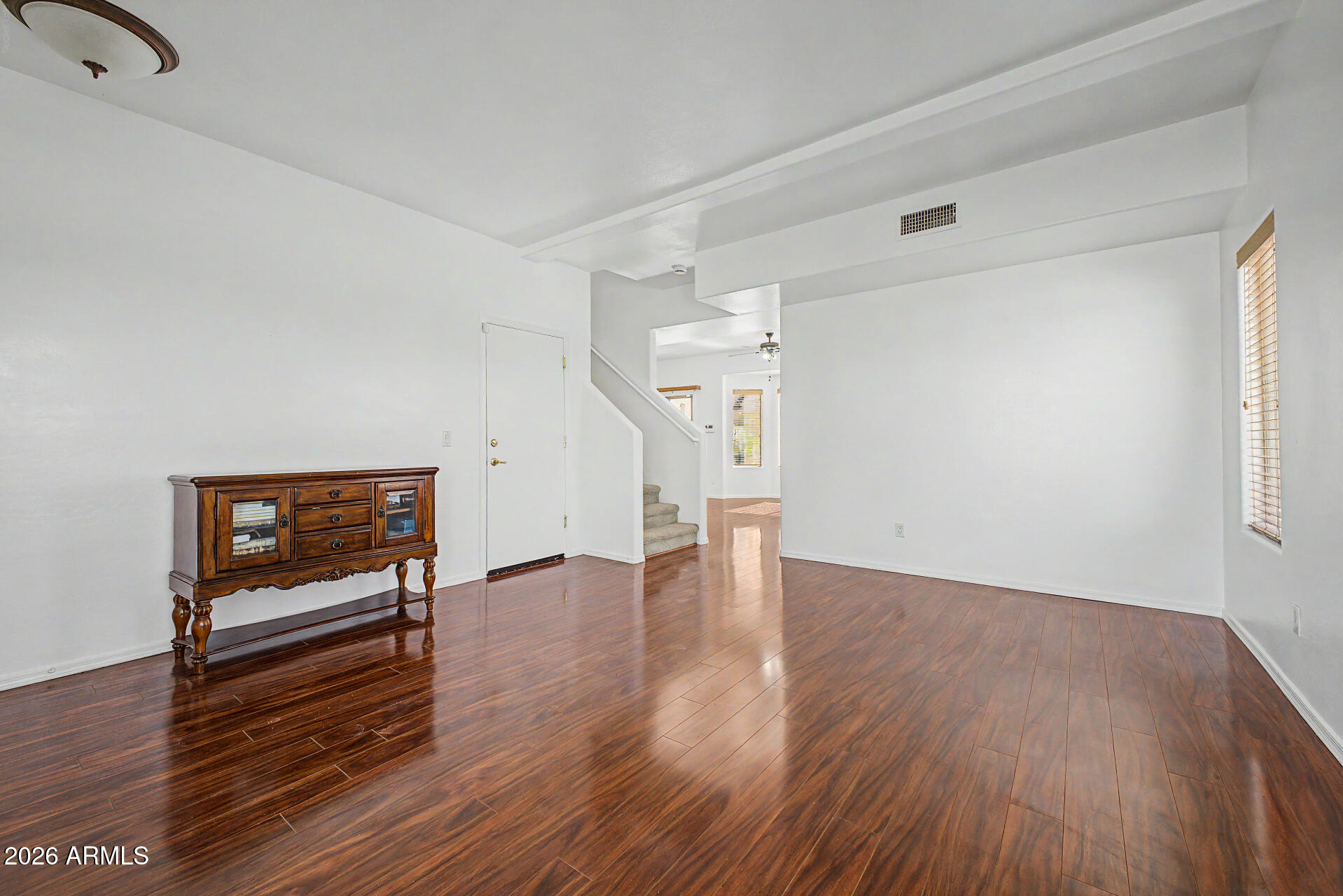 7206 South 12th Way Phoenix, AZ 85042 - Photo 2 of 34 wooden floor in an empty room with a window