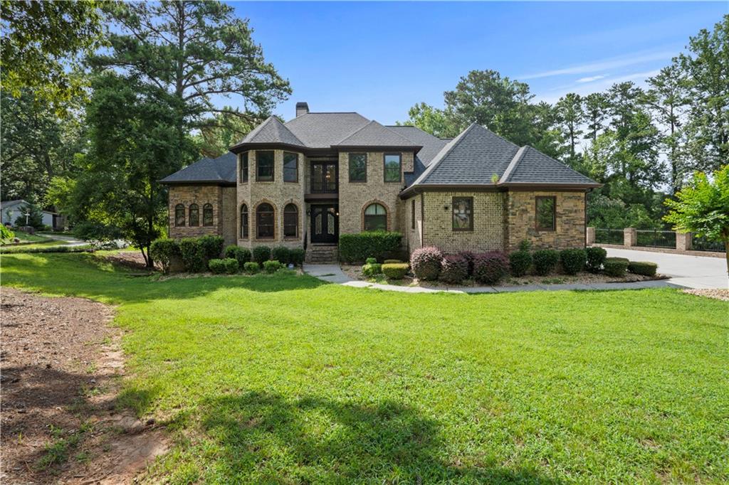 3970 Demooney Road Atlanta, GA 30349 - Photo 1 of 1 a front view of a house with a garden