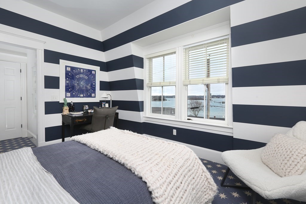 2 Merrill Street Hingham, MA 02043 - Photo 18 of 34 a large bedroom with a bed and wooden floor