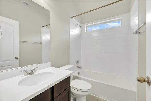 a view of large house with a wooden fence