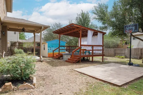 a view of a house with backyard porch and sitting area