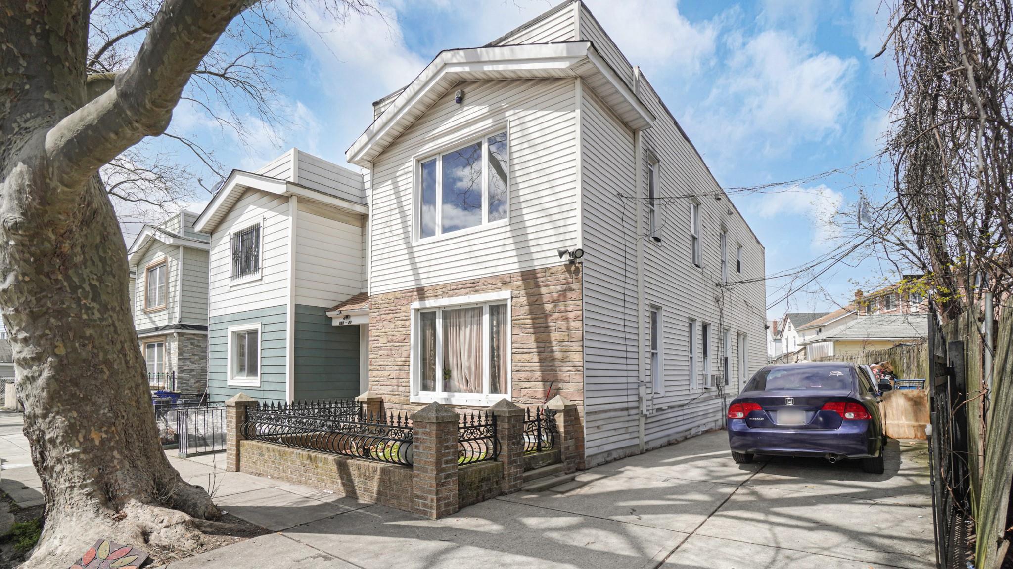 a car parked in front of a white house