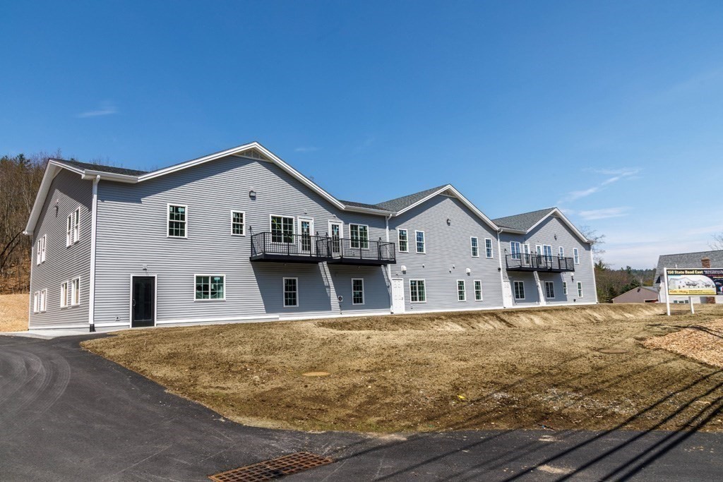 150 State Road East, Unit 12 Westminster, MA 01473 - Photo 13 of 13 a front view of a house with large trees