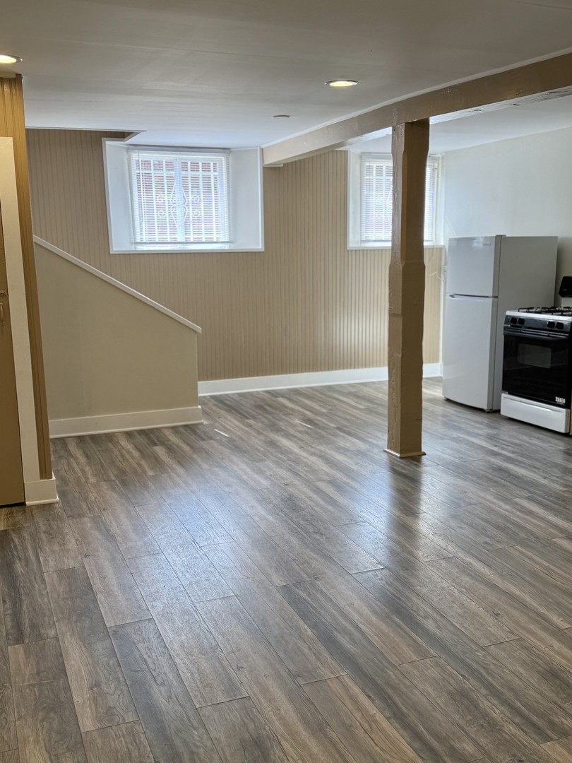 6 National Street, Unit 1 Elgin, IL 60123 - Photo 3 of 6 a view of empty room with wooden floor