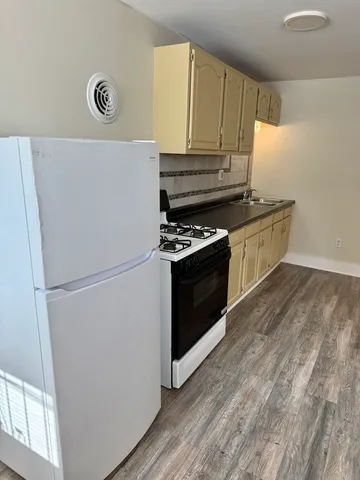 a kitchen with a refrigerator and a stove
