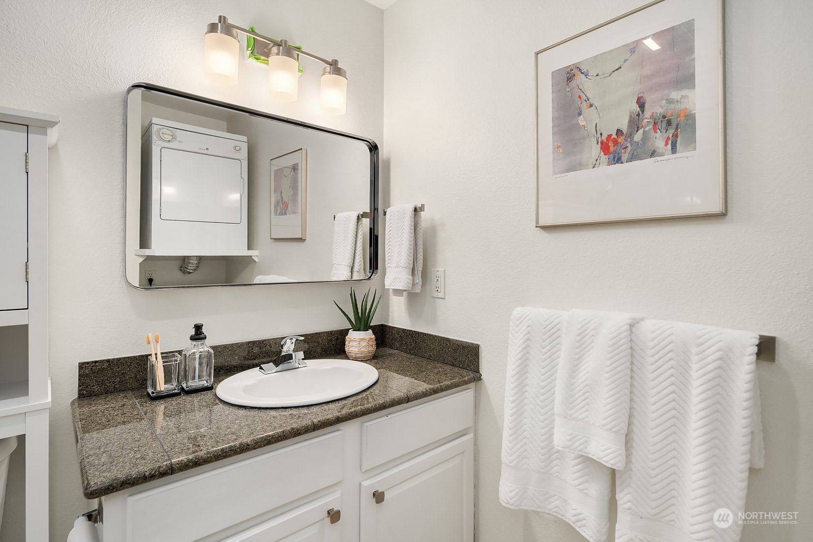 20324 Bothell Everett Highway, Unit F 301 Bothell, WA 98012 - Photo 20 of 28 a bathroom with a granite countertop sink and a mirror