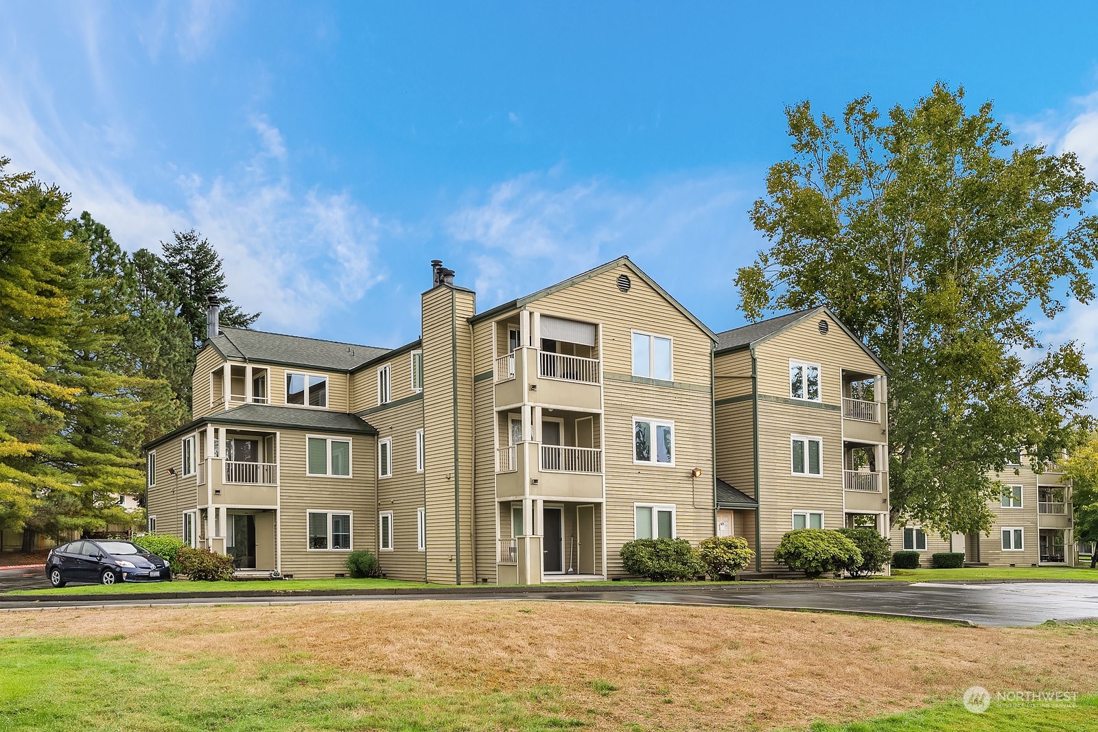 20324 Bothell Everett Highway, Unit F 301 Bothell, WA 98012 - Photo 23 of 28 a front view of a building with a garden