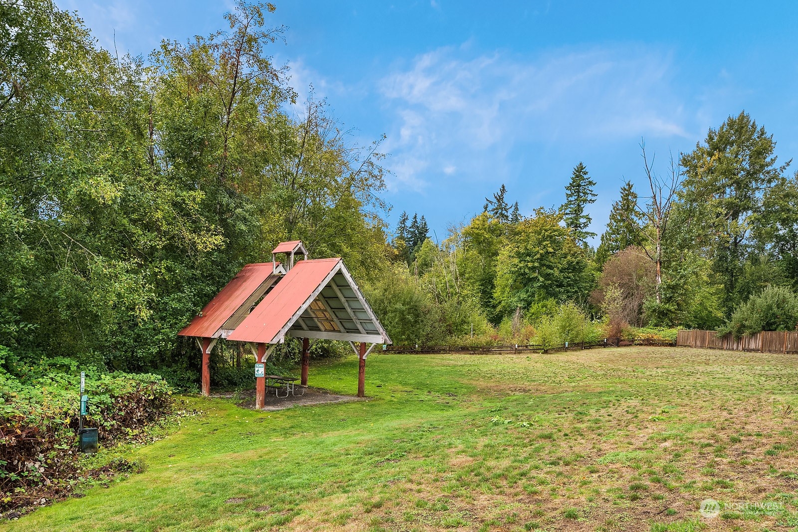 20324 Bothell Everett Highway, Unit F 301 Bothell, WA 98012 - Photo 27 of 28 a backyard of a house with table and chairs