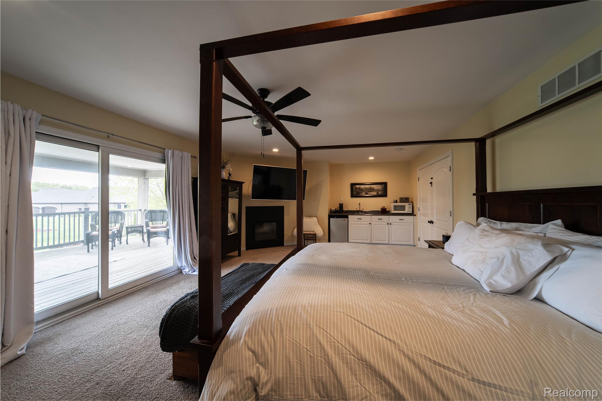 67102 Rachael Lane Washington, MI 48095 - Photo 26 of 37 Carpeted bedroom featuring access to exterior, a fireplace, ceiling fan, and recessed lighting