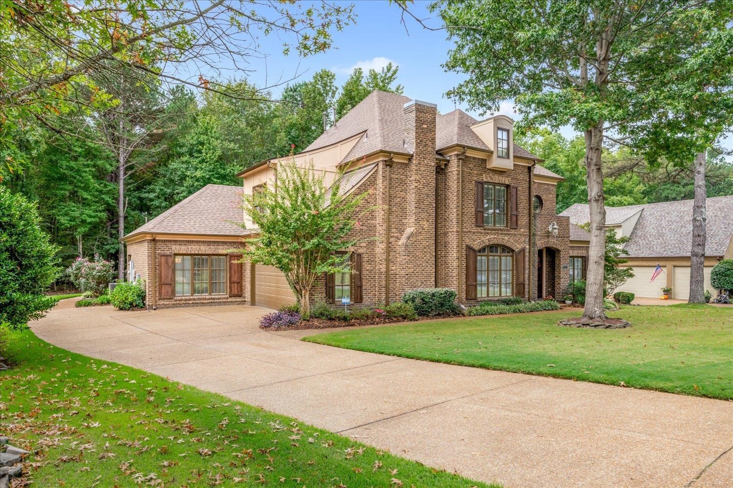 4597 Whisper Spring Drive Collierville, TN 38017 - Photo 2 of 39 a front view of a house with a garden and trees