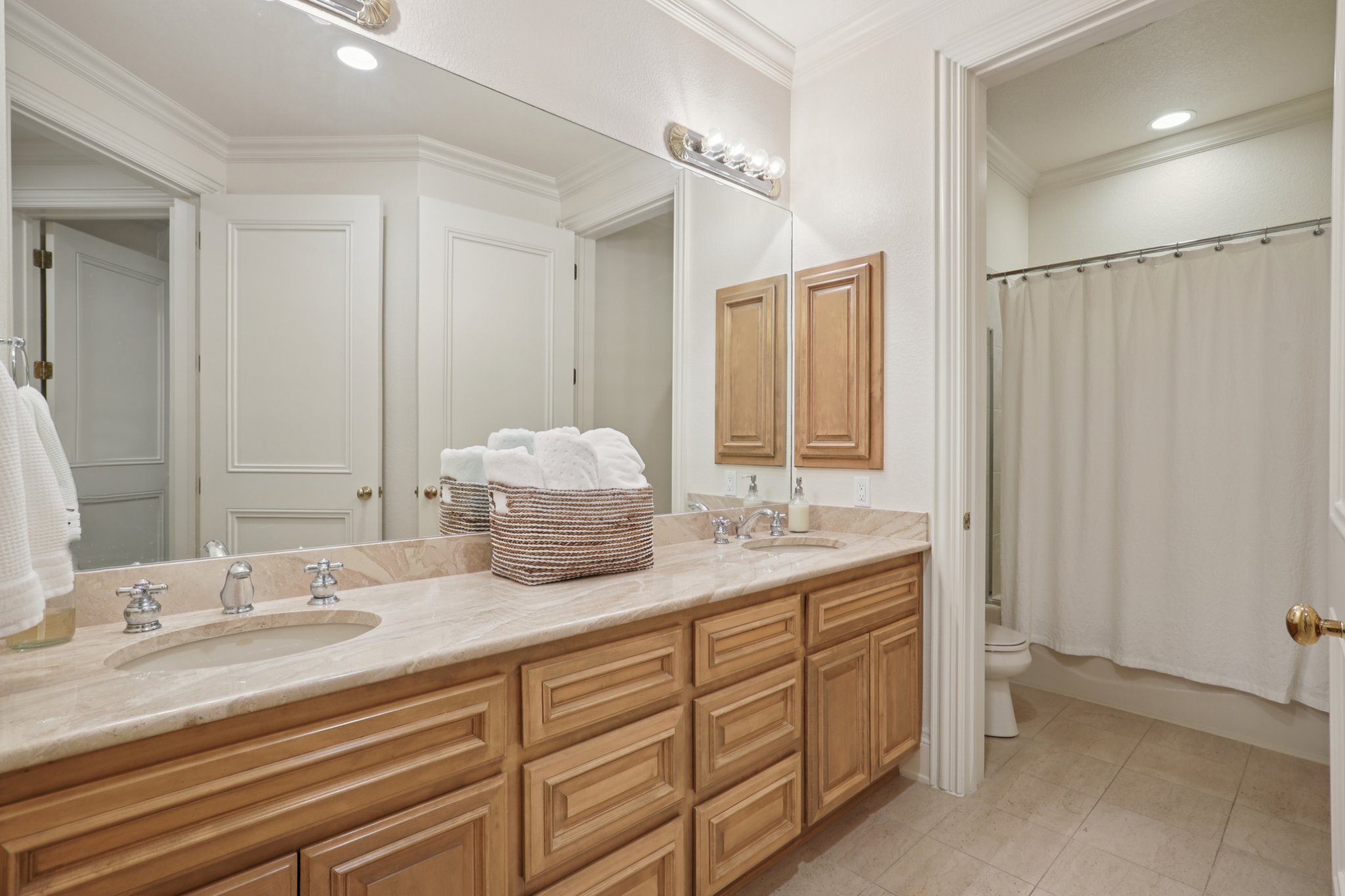 14701 Hornsby Hill Road Austin, TX 78734 - Photo 17 of 40 a bathroom with double sink and a mirror