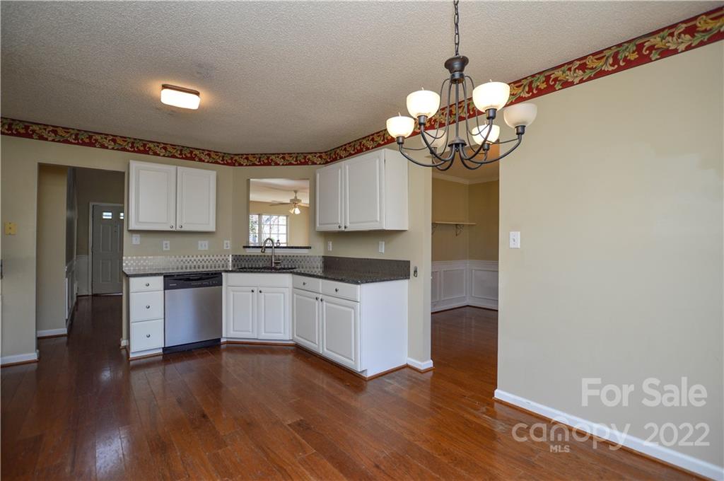 7608 Henderson Park Road Huntersville, NC 28078 - Photo 12 of 39 a kitchen with a refrigerator and a stove top oven