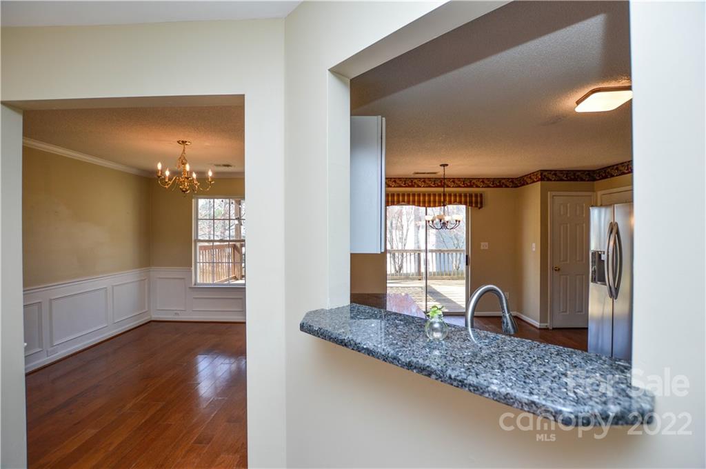 7608 Henderson Park Road Huntersville, NC 28078 - Photo 17 of 39 a view of a bathroom with tub windows and wooden floor