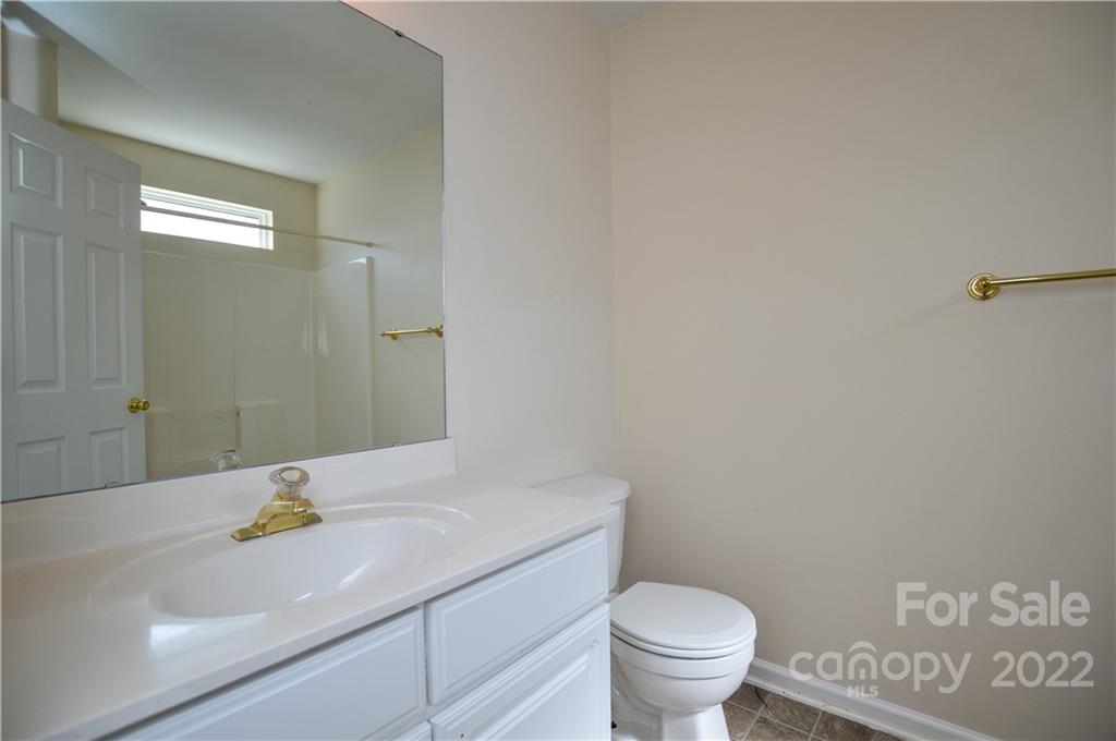 7608 Henderson Park Road Huntersville, NC 28078 - Photo 23 of 39 a bathroom with a sink a toilet and a mirror