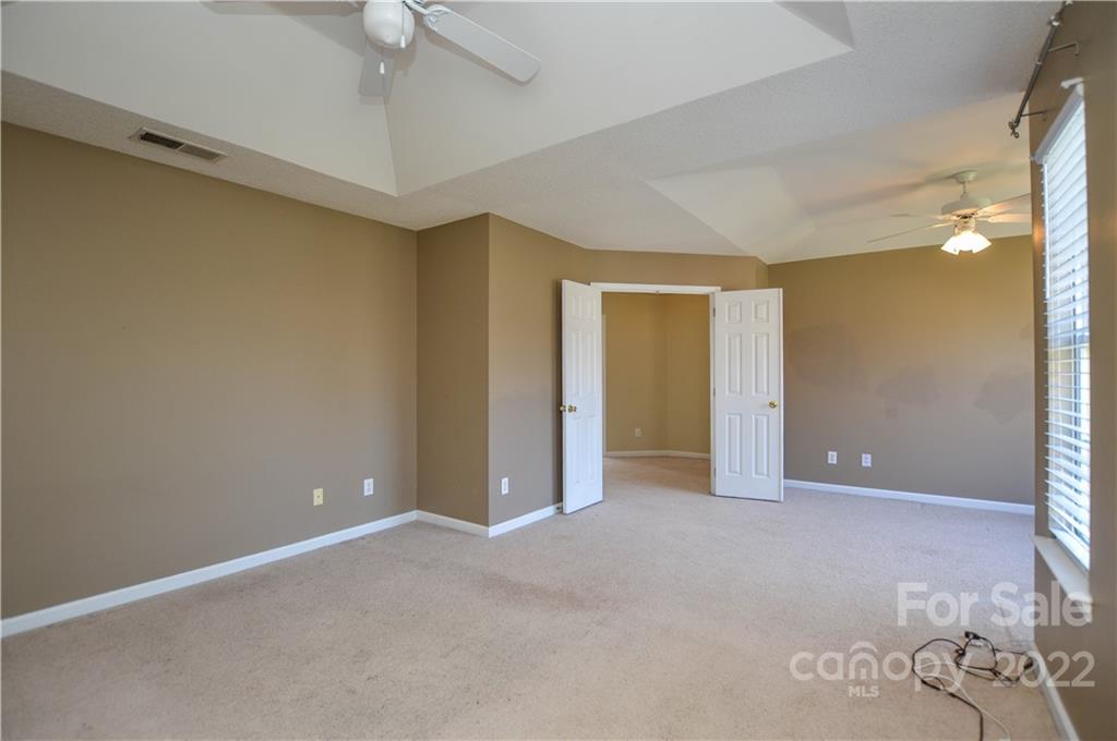 7608 Henderson Park Road Huntersville, NC 28078 - Photo 25 of 39 a view of an empty room with a ceiling fan
