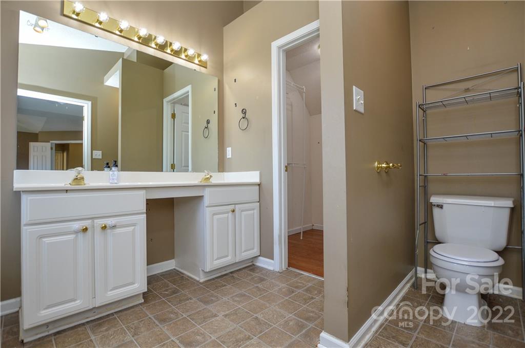7608 Henderson Park Road Huntersville, NC 28078 - Photo 28 of 39 a bathroom with a sink a toilet and a mirror