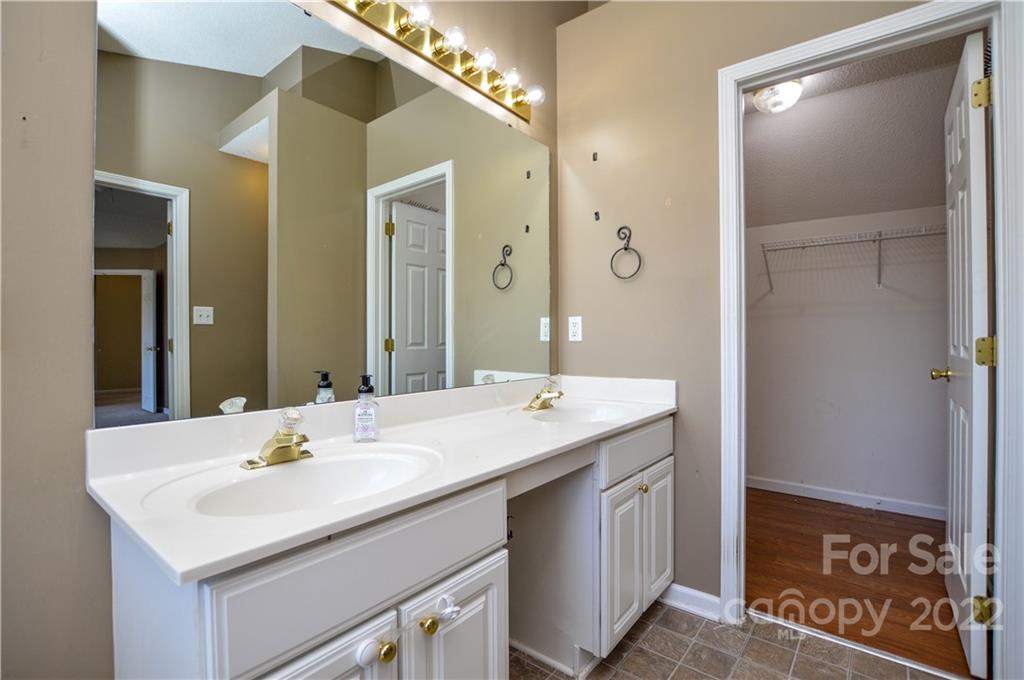 7608 Henderson Park Road Huntersville, NC 28078 - Photo 30 of 39 a bathroom with a sink vanity and a mirror