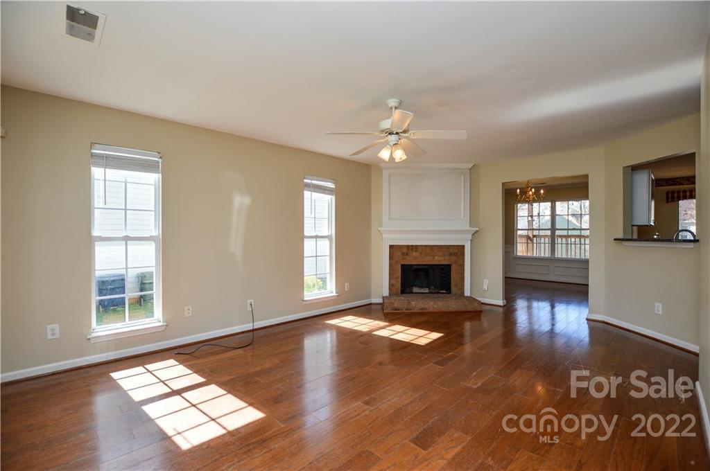 7608 Henderson Park Road Huntersville, NC 28078 - Photo 6 of 39 a view of an empty room with window and wooden floor