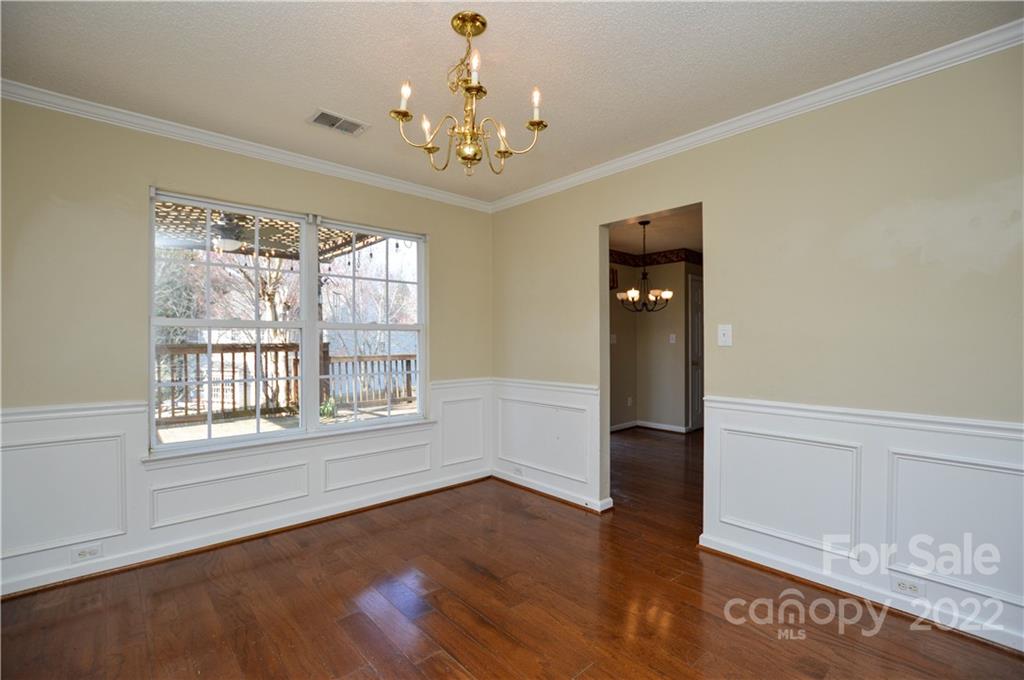 7608 Henderson Park Road Huntersville, NC 28078 - Photo 10 of 39 a view of an empty room with wooden floor and a window