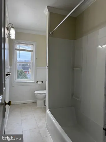 a bathroom with a bathtub and a toilet