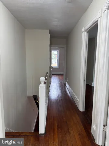 a view of hallway with wooden floor