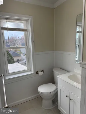 a white toilet sitting next to a bathroom sink