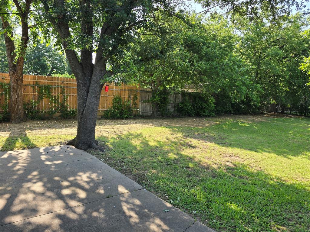 1000 Springdale Road Bedford, TX 76021 - Photo 32 of 36 Spacious backyard with privacy fence between neighbors.