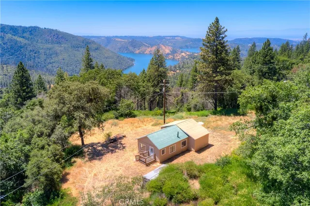 an aerial view of a house with yard swimming pool and mountain view