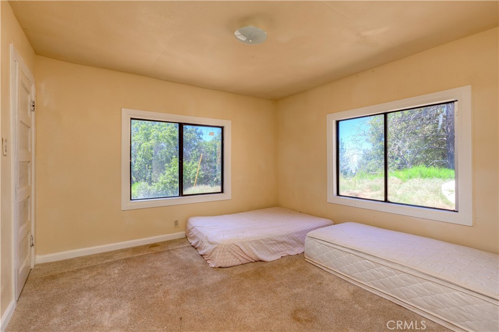 13545 Surcease Mine Road Oroville, CA 95965 - Photo 20 of 28 a bedroom with a bed and a window