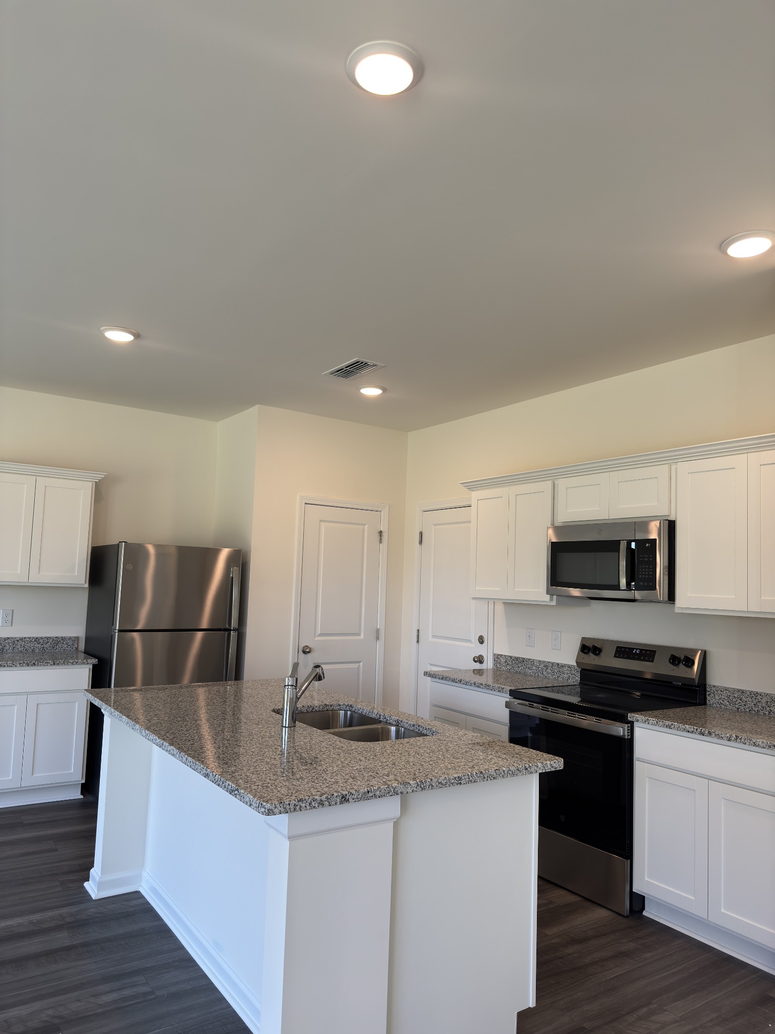 159 Snowdrop Avenue La Vergne, TN 37086 - Photo 2 of 16 a kitchen with stainless steel appliances granite countertop a sink a stove top oven a counter space and cabinets