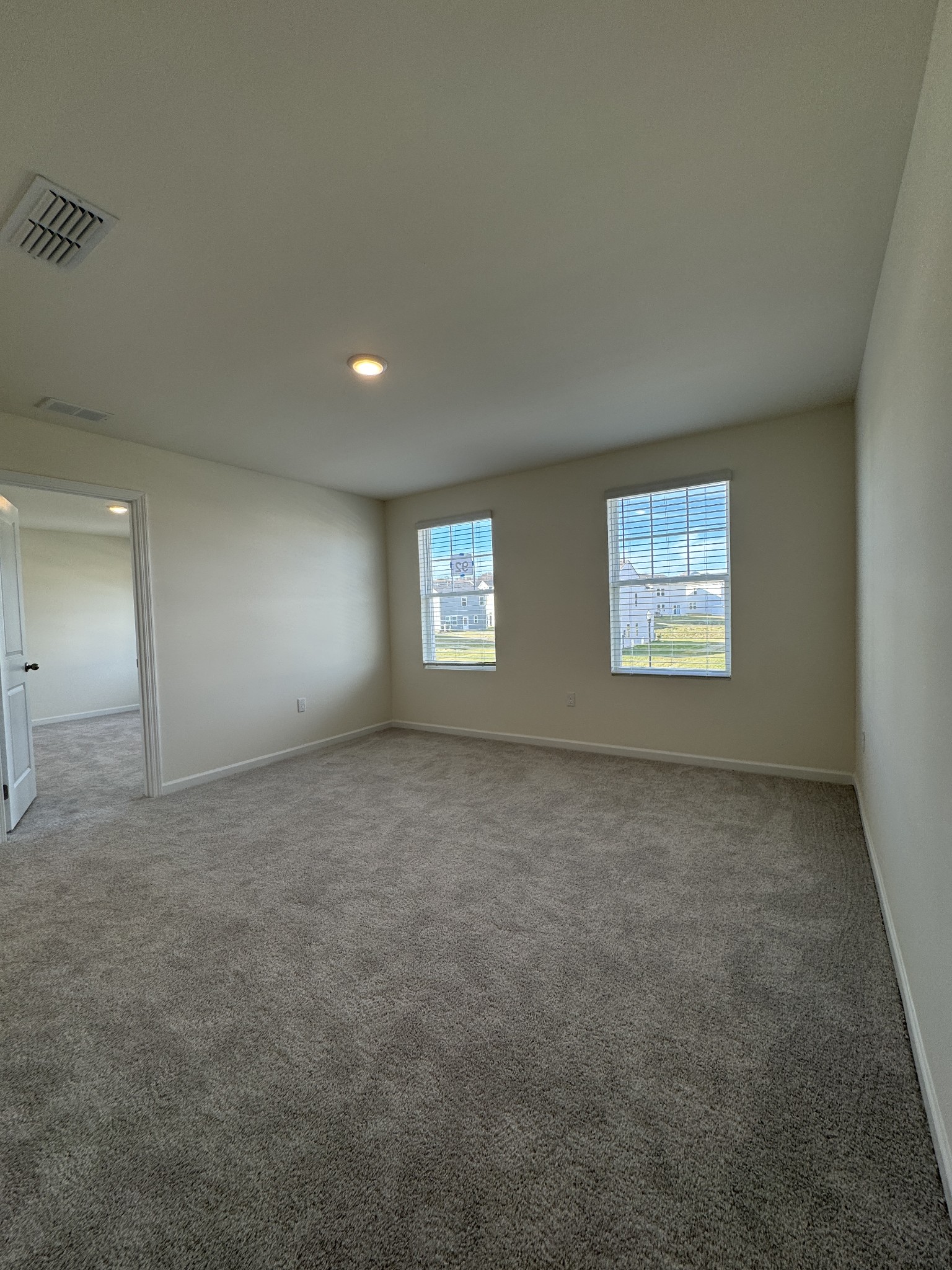 159 Snowdrop Avenue La Vergne, TN 37086 - Photo 4 of 16 a view of an empty room with a window and a kitchen