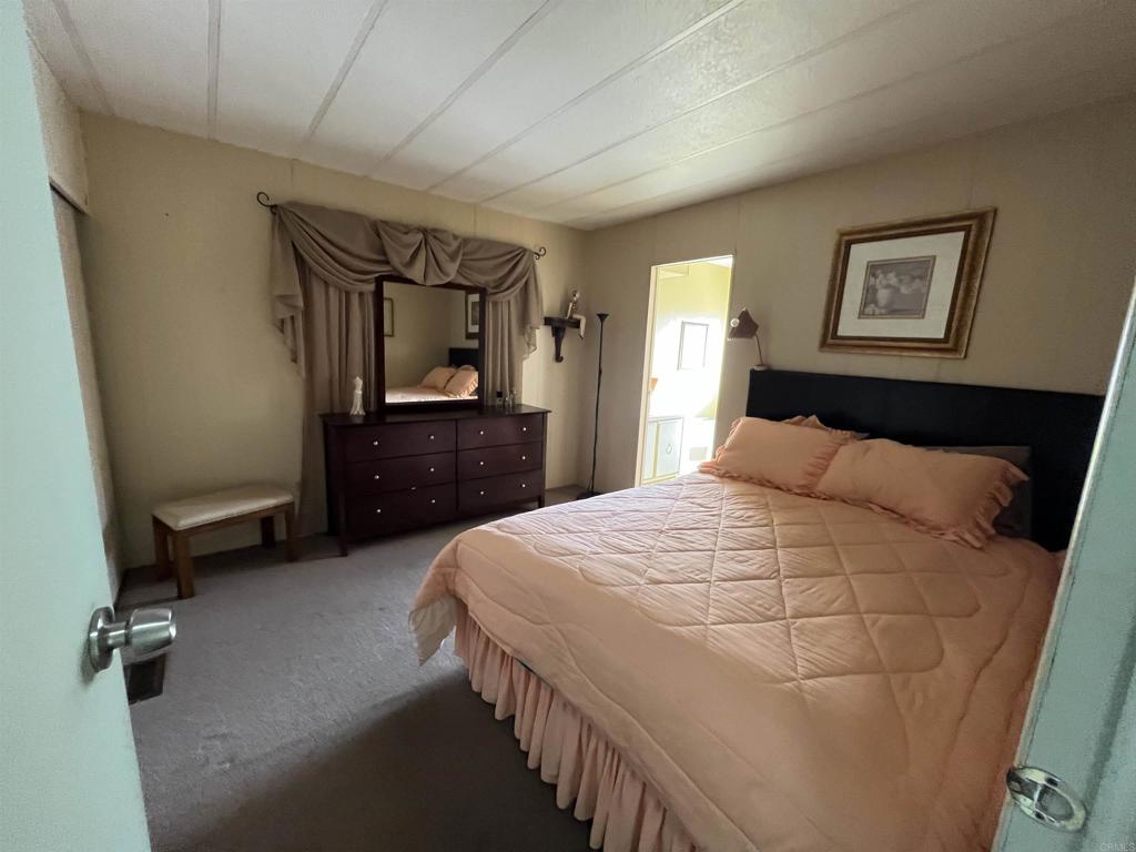 1810 Hillsdale Road, Unit 99 El Cajon, CA 92019 - Photo 10 of 15 a bedroom with a bed and a bathroom