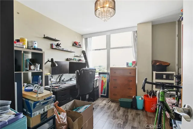 a view of a workspace with furniture and a window