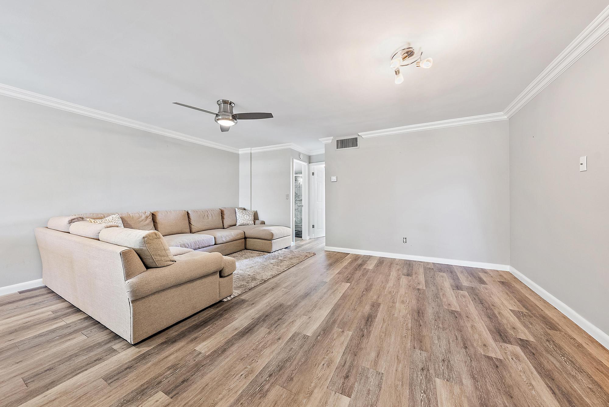 109 Paradise Harbour Boulevard, Unit 307 North Palm Beach, FL 33408 - Photo 11 of 20 a living room with furniture and a ceiling fan