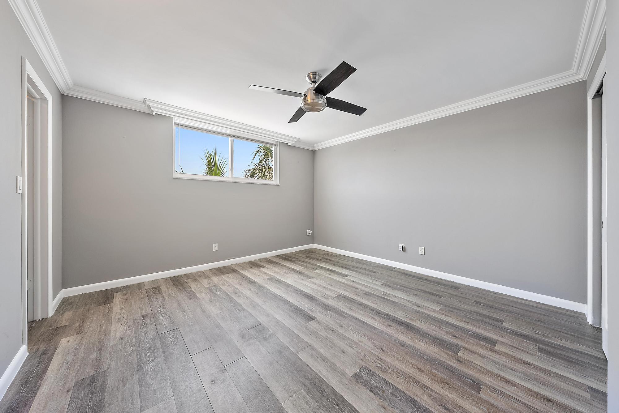 109 Paradise Harbour Boulevard, Unit 307 North Palm Beach, FL 33408 - Photo 13 of 20 wooden floor in an empty room with a window