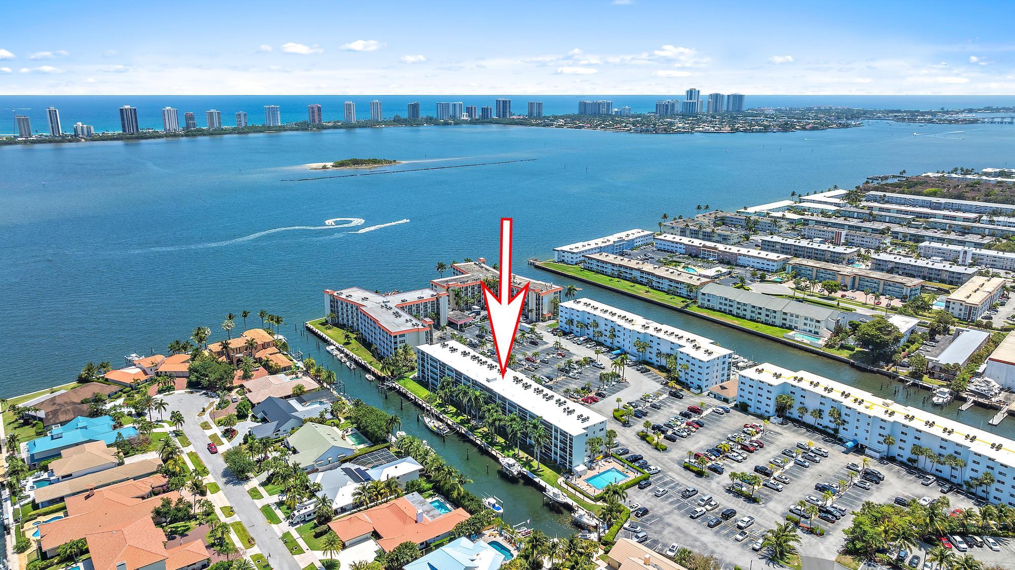 109 Paradise Harbour Boulevard, Unit 307 North Palm Beach, FL 33408 - Photo 2 of 20 a view of a lake with a building in the background
