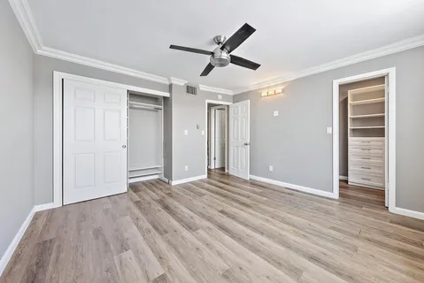 a view of empty room with wooden floor