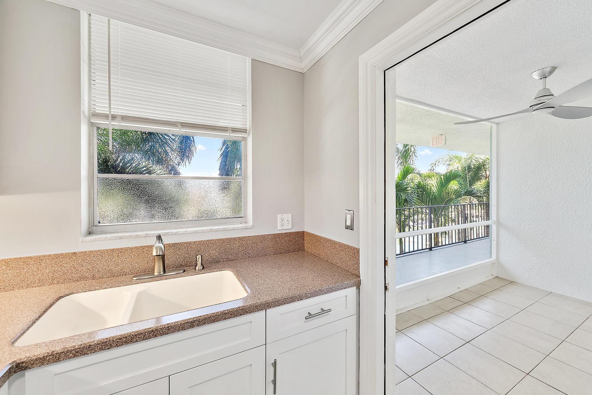 109 Paradise Harbour Boulevard, Unit 307 North Palm Beach, FL 33408 - Photo 8 of 20 a bathroom with a granite countertop sink mirror and window