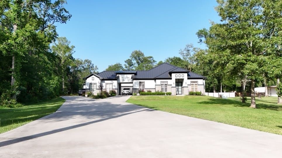 0 Riverview Crossing Huffman, TX 77336 - Photo 9 of 11 a front view of a house with a yard and trees
